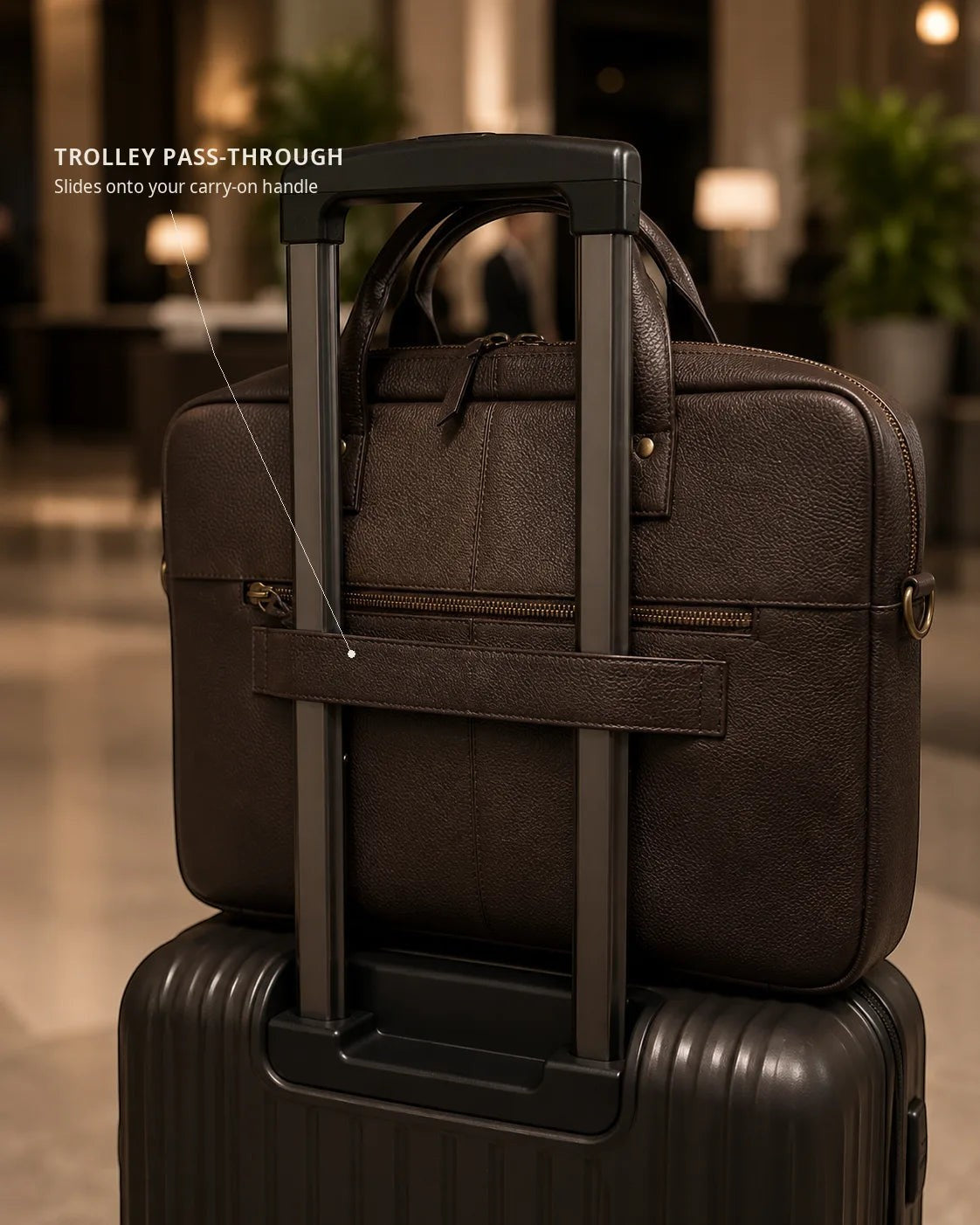 Wildebeast The Wayfarer dark brown pebbled leather work bag attached to a suitcase handle via a trolley sleeve.