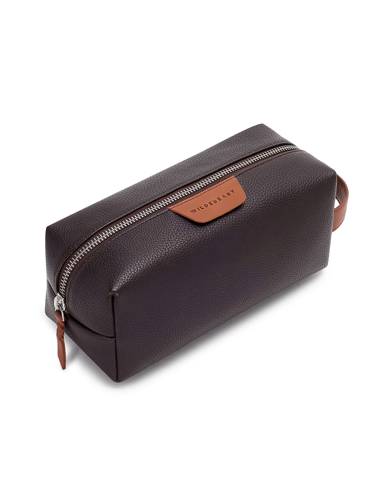 The Geeky Dopp Kit brown leather dopp kit, angled view showing the zip and tan logo patch