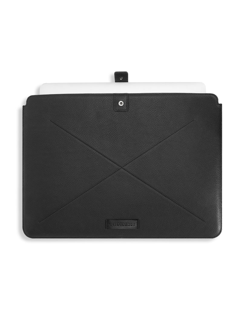 Wildebeast The Keeper black leather laptop sleeve with snap-tab strap and a laptop inside