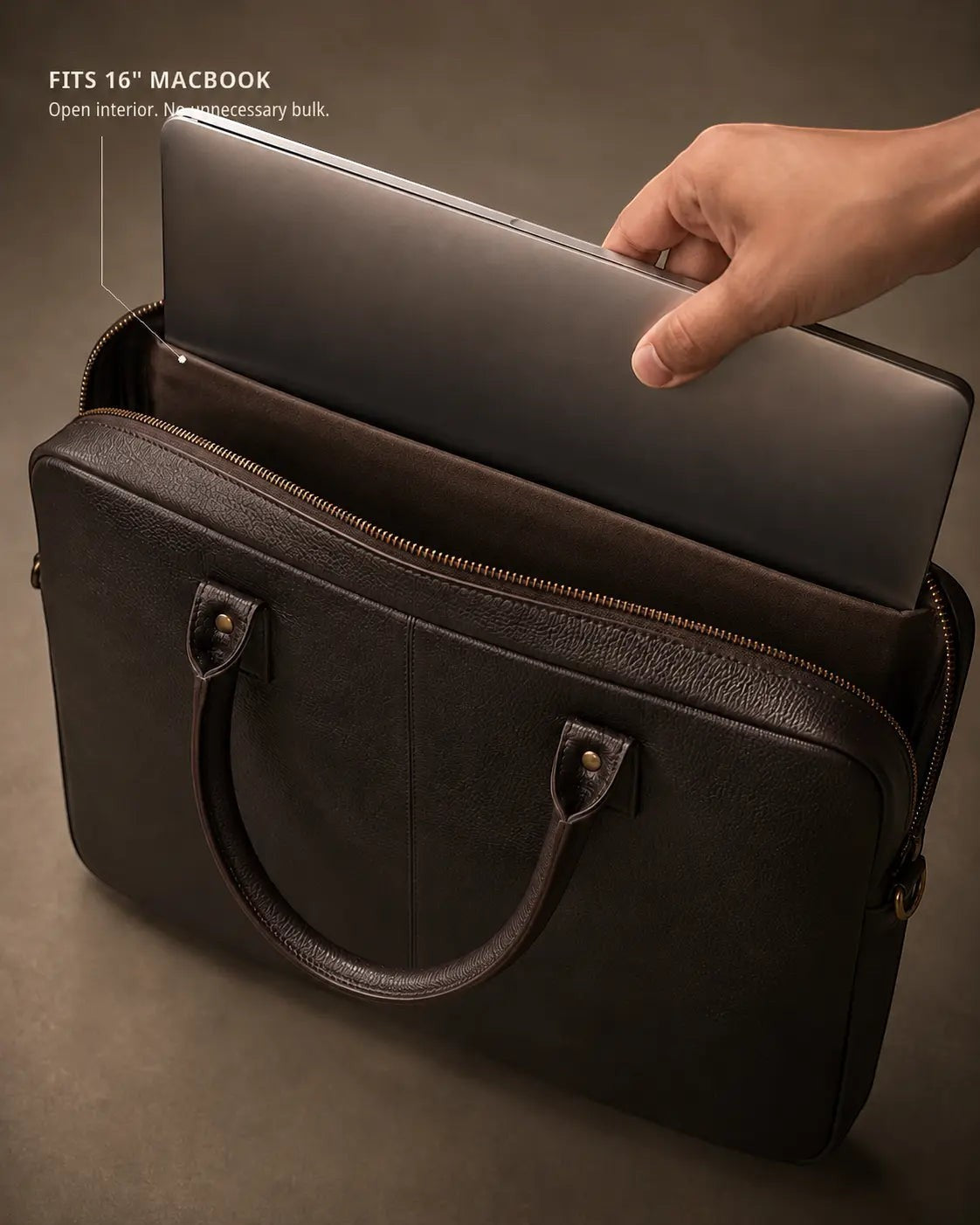 Wildebeast The Wayfarer dark brown pebbled leather work bag holding a 16-inch MacBook with antique metal hardware